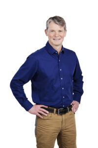 Man in blue shirt and brown pants