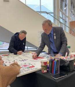 President and CEO Claude Brulé participates in the mural exercise to honour International Day of Remembrance and Action on Violence Against Women.