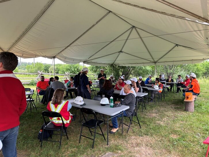 volunteers from PCL, Nokia and TD having a break under a large white tent