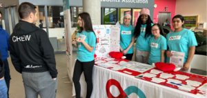 Students in E Building at an information table raising awareness for Canadian Blood Services