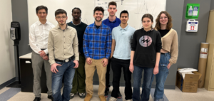 Students standing in a row in engineering classroom