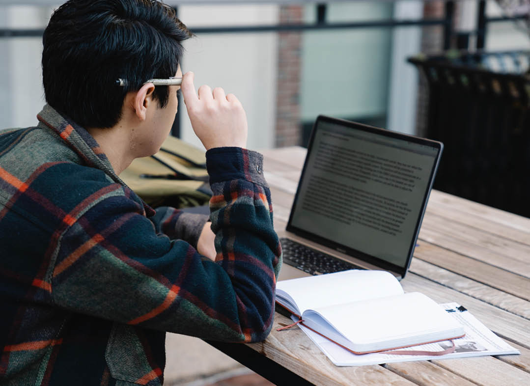 Photo of a student doing their school work on a laptop.