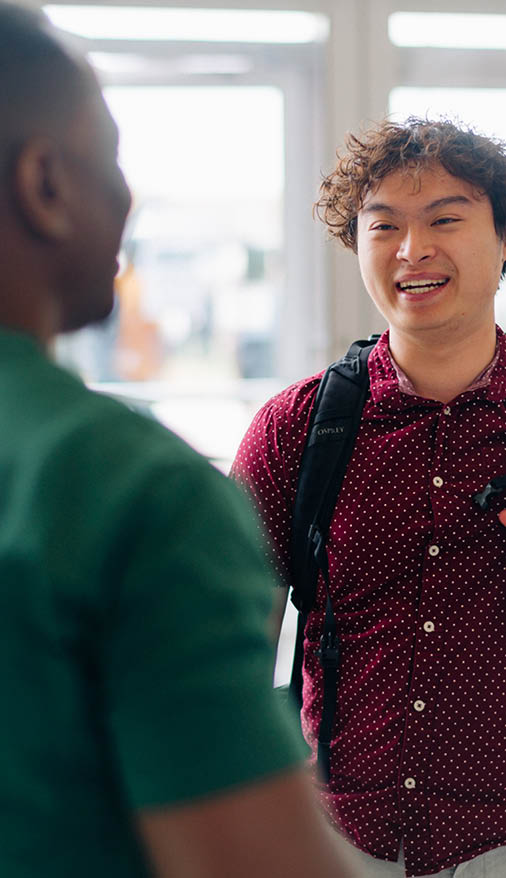 Photo of Card Services employees helping students to collect their AC Cards. 