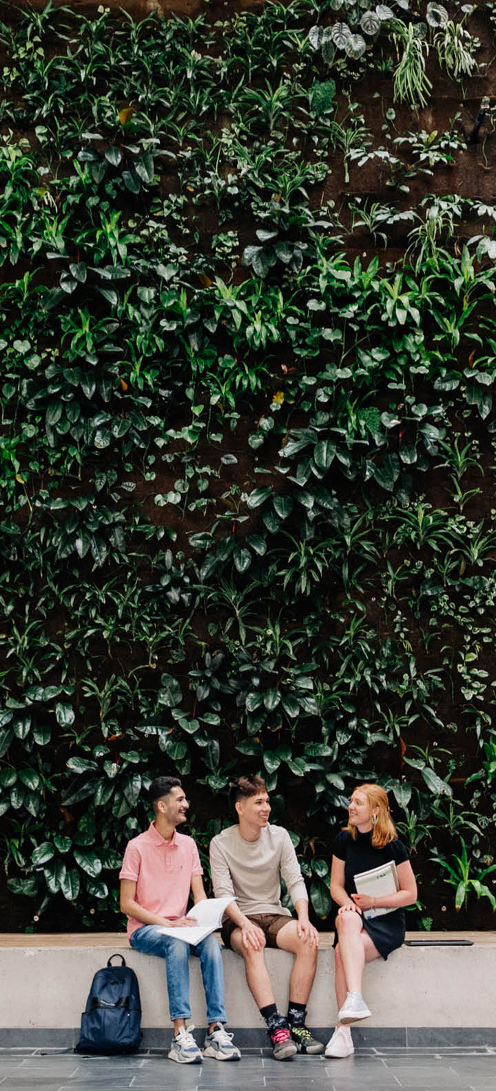 Photo of 3 students sitting at the Green Wall in the ACCE/CA Building