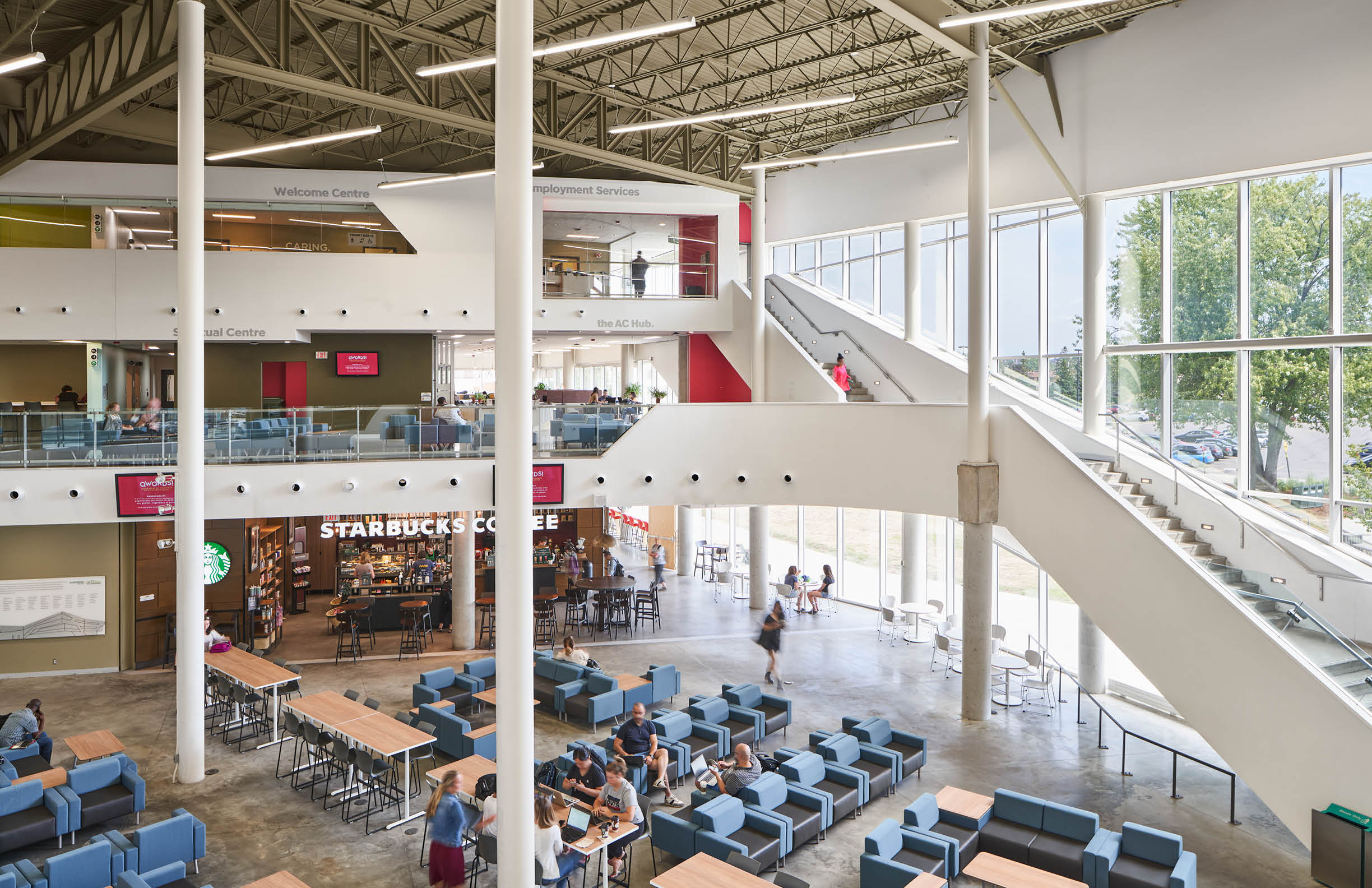Photo of the inside of the Student Commons/E Buildling from the upper floor. Starbucks, the AC Hub, and Welcome Centre are visable. 