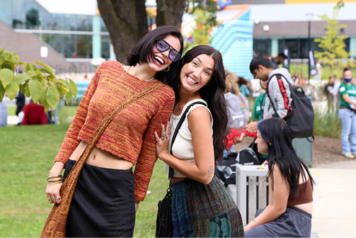 Two students take a photo together outside at AC Day 1.