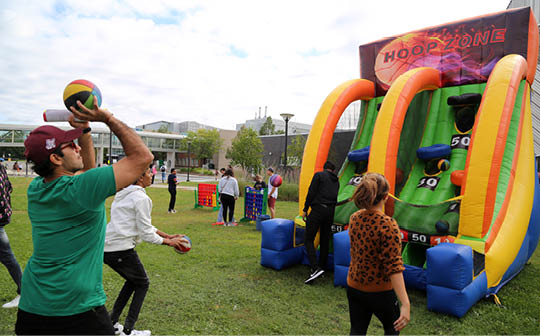 Photo of a student taking a basketball shot at a game during AC Day 1.