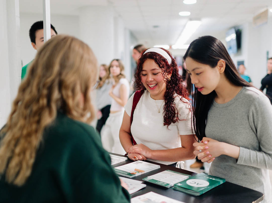 Photo of two students at the Printshop services on campus. 