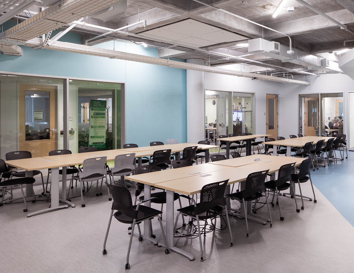 Photo of a student picking up their AC Card from Card Services employees. 