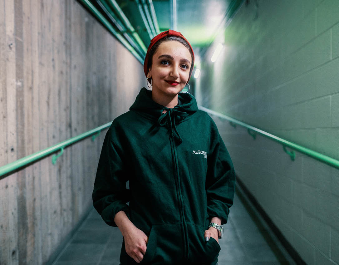 Close-up photo of someone's hands on a laptop with a bright screen. 