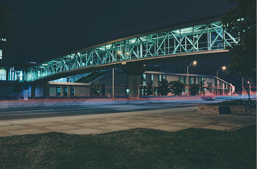 Photo of the ACCE Building Bridge at the Ottawa campus at night.