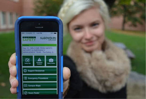 Student showing College Safety App on their phone to the camera.