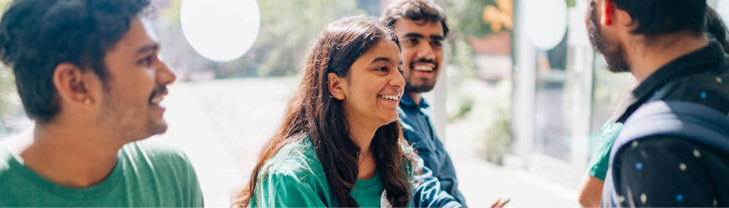 Student volunteer outside the A Building at the Ottawa Campus blowing bubbles at an event. 