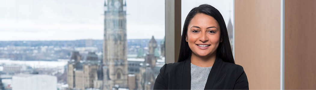 Professional Student smiling with the Ottawa landscape in the background.