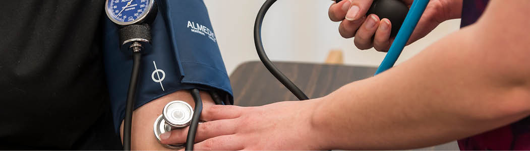 Close-up photo of someone getting their blood pressure taken.