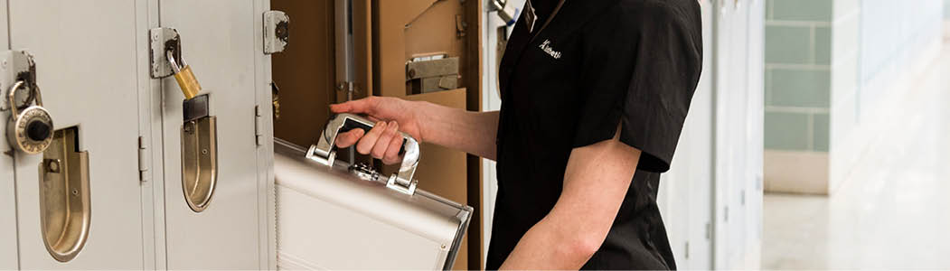 Photo of a student pulling supplies out of their locker.