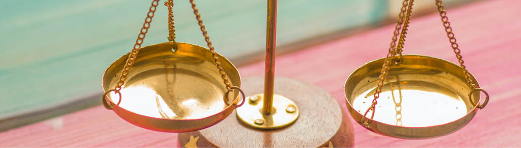 Close-up photo of a balanced brass scale with nothing on it.