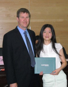 Tang Yan accepts her diploma from Ernest Mulvey - Director of Algonquin's International Education Centre