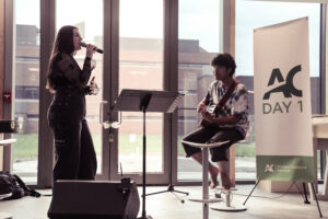 Photo of a singer and guitarist at AC Day 1.