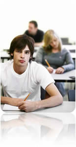 Young man sitting in a classroom looking at camera