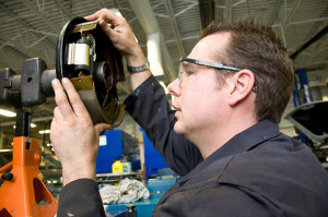 A MPT student working on a brake system