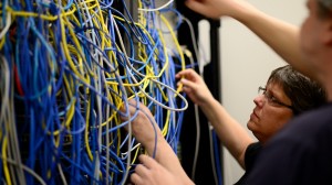 Two students examine network wiring in computer lab - Student experience in Computer Systems Technician