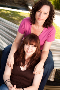 mother and college-age daughter sitting on hammock