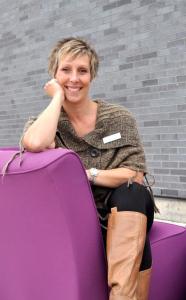 smiling woman sitting on purple couch