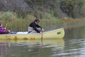 A male Environmental Technician student paddling a canoe on Snake River