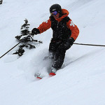 Outdoor adventure graduate Marcie Trenholm skiing down steep slope - Grad Success Stories