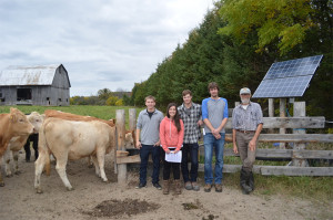 A group of Environmental Technician students  outside on a sunny day at a beef cattle farm