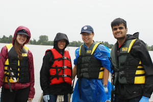 Applied Research summer co-op technicians and high school students in rain gear and life jackets