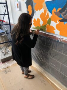 Students and Staff painting mural