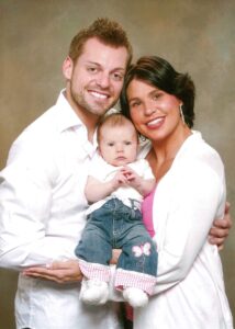 Scott Vernelli and Marcie Lane hold their infant daughter Olivia