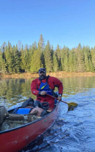 An Outdoor Adventure student canoeing.