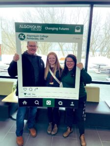 A family poses with a teacher at March Break Open House at Algonquin College