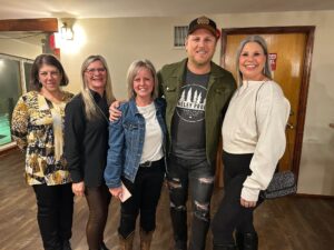 Jason Blaine poses for a picture with other alumni from Algonquin College's Pembroke Campus.