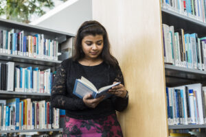 Student studying in campus library.