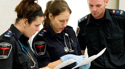 Paramedic students consult assessment checklist