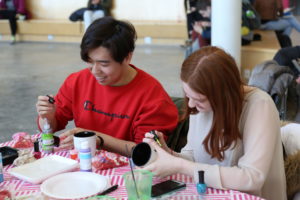 Students Decorating Mugs at Valentine's Day event