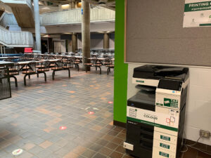 Image of a Konica Minolta colour printer on the first floor of B building in the Rotunda located across from The Portable Feast.