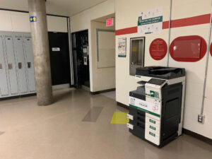 Image of a Konica Minolta colour printer on the second floor of B building in the hallway outside of room B217.