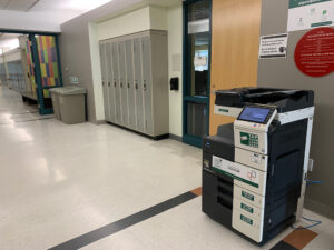 Image of a Konica Minolta colour printer on the third floor of J building in the hallway outside of room J310.