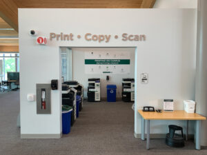 Image of four Konica Minolta colour printers located within the Library's Print Copy Scan area in C building room C350.