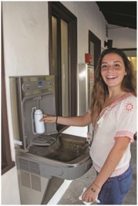 woman smiling at water refill station