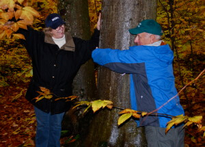 Fred Blackstein, Vice Chair, Algonquin Board of Governors, shows Karen Davies, Dean, Waterfront Campus, how to properly hug a tree during a hike at Shaw Woods Outdoor Education Centre